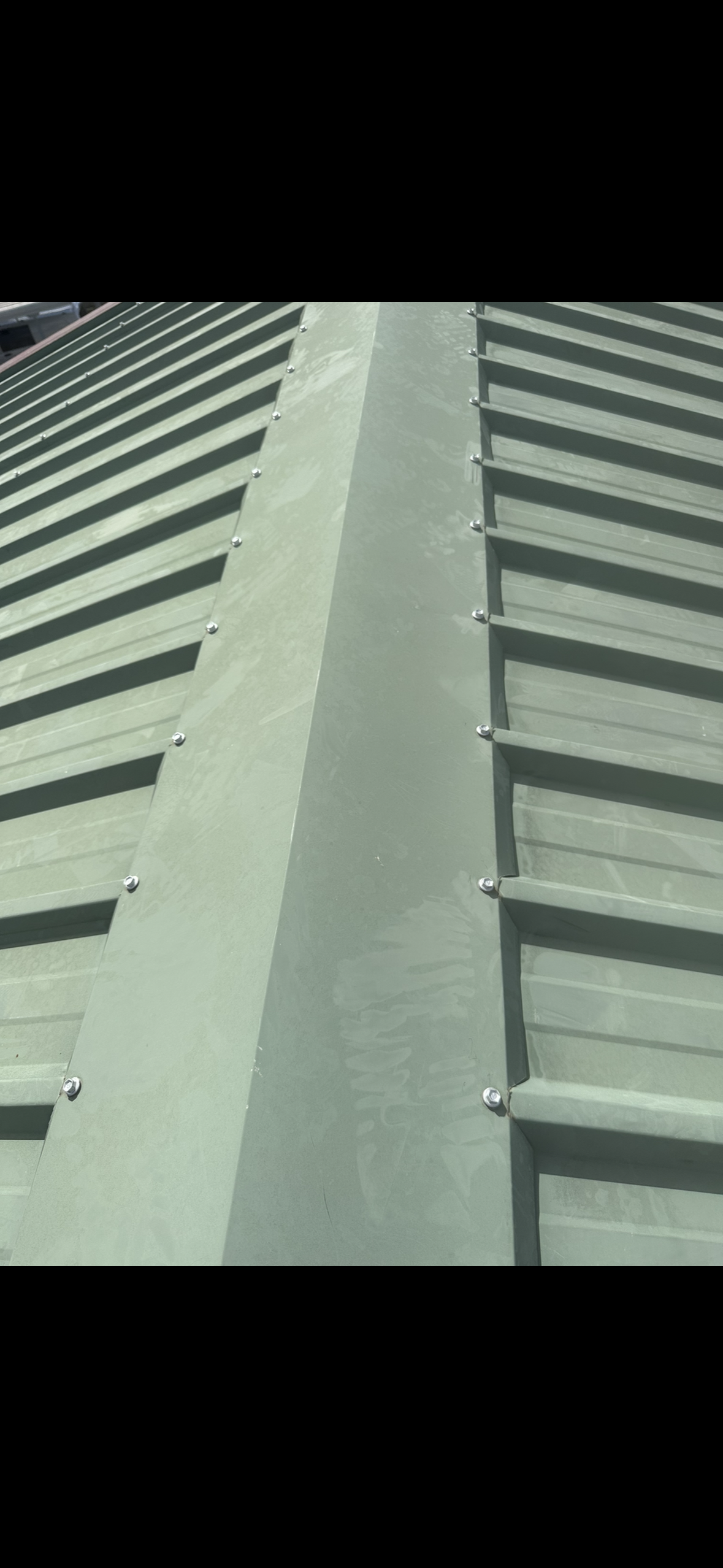 Close-up of a Light Green Metal Roof — Whirly Bird King in Strathpine, QLD