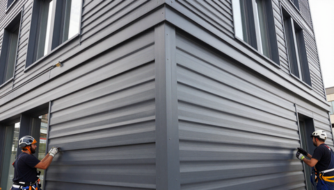 Metal siding panel installation on commercial building