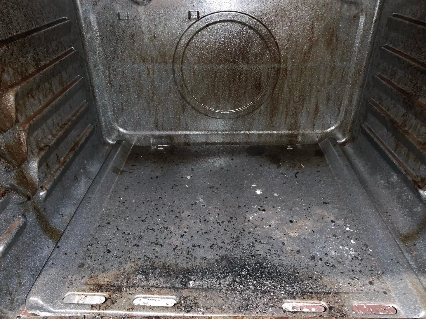The inside of an oven is very dirty and needs to be cleaned.