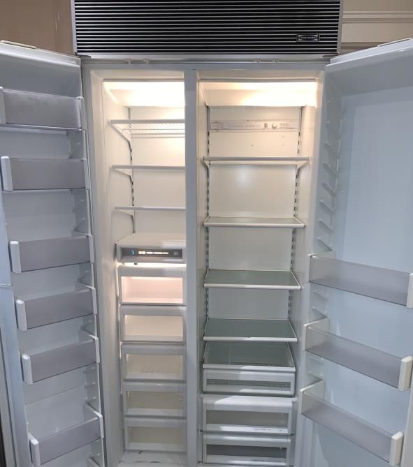 The inside of an empty refrigerator with the doors open
