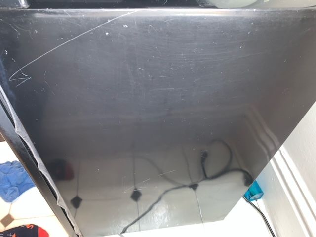 A black box with a broken corner is sitting on a table.
