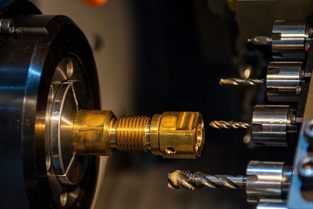 A Machine is Cutting a Piece of Metal With Drills — LM Engineering In Mareeba, QLD
