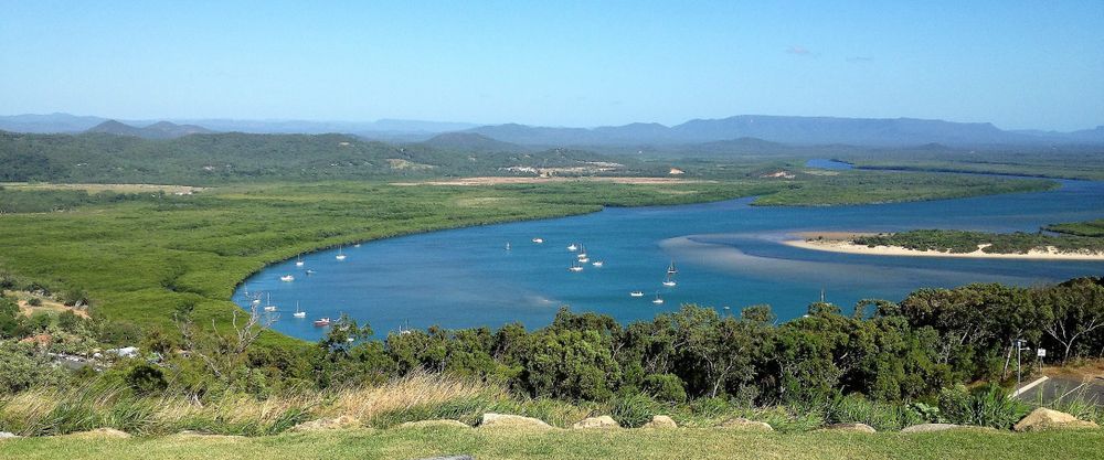 A Wide Shot Of A Blue River With Boats Surrounded By Green — LM Engineering In Cooktown, QLD