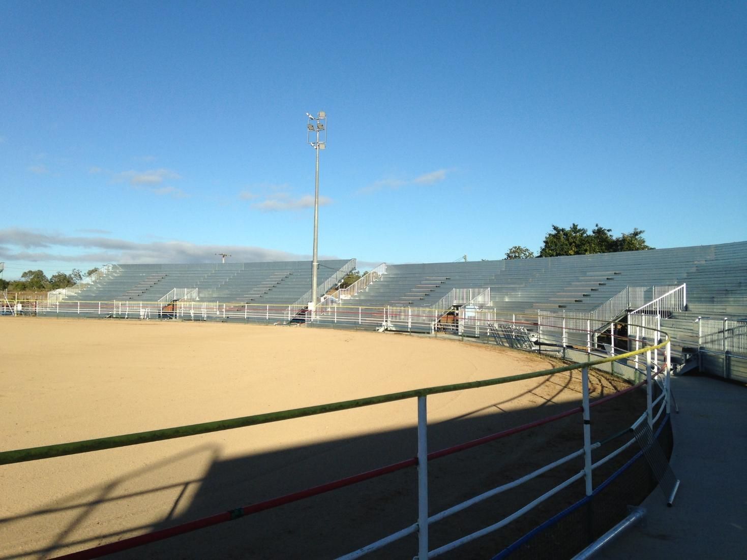 A Stadium With Empty Bleachers and a Blue Sky in the Background — LM Engineering In Mareeba, QLD