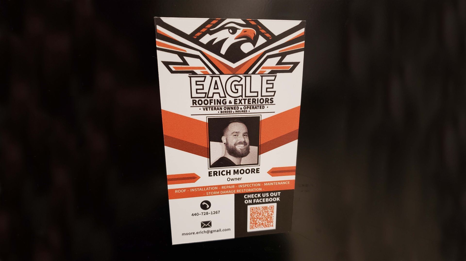 A photo of a magnet of Eagle Roofing and Exteriors with contact information to reach the company.