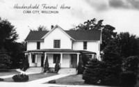 A black-and-white postcard showing the Haudenshield Funeral Home in Cuba City, Wisconsin, a two-story house with a porch.