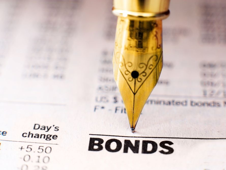 A fountain pen is sitting on a piece of paper that says bonds