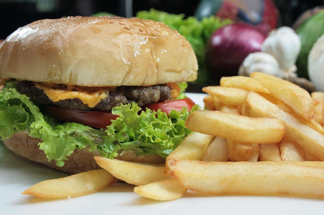 a hamburger and french fries on a white plate