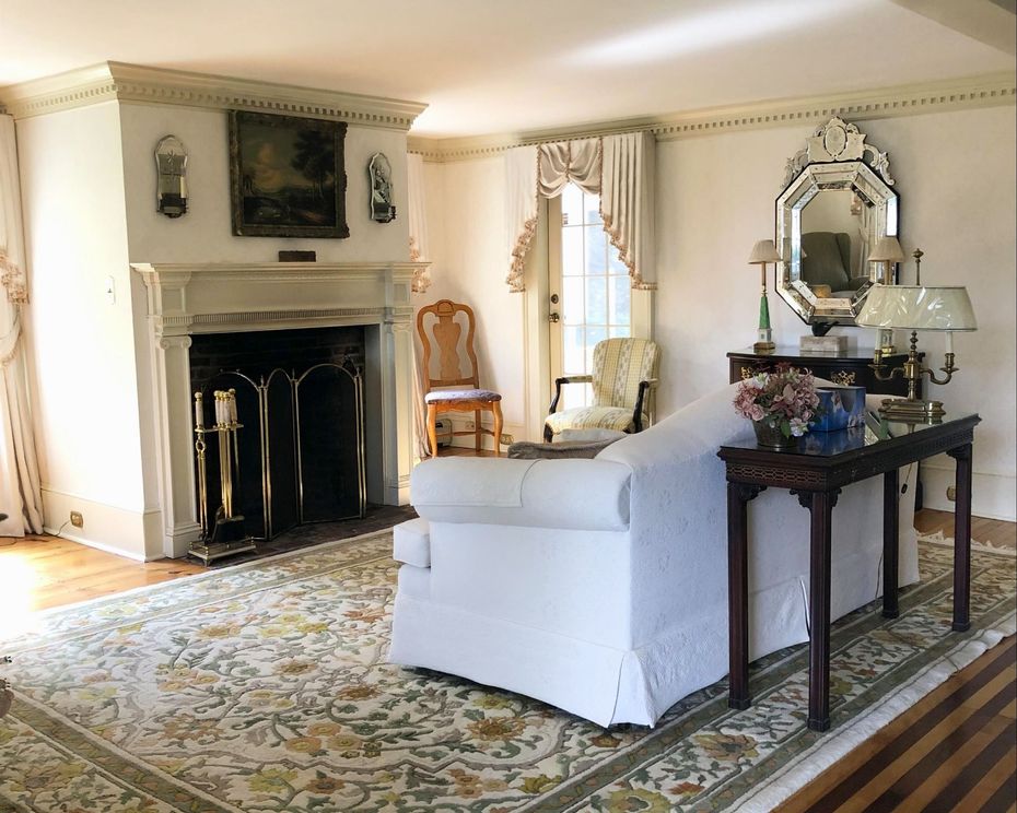 a living room with a fireplace and a white couch
