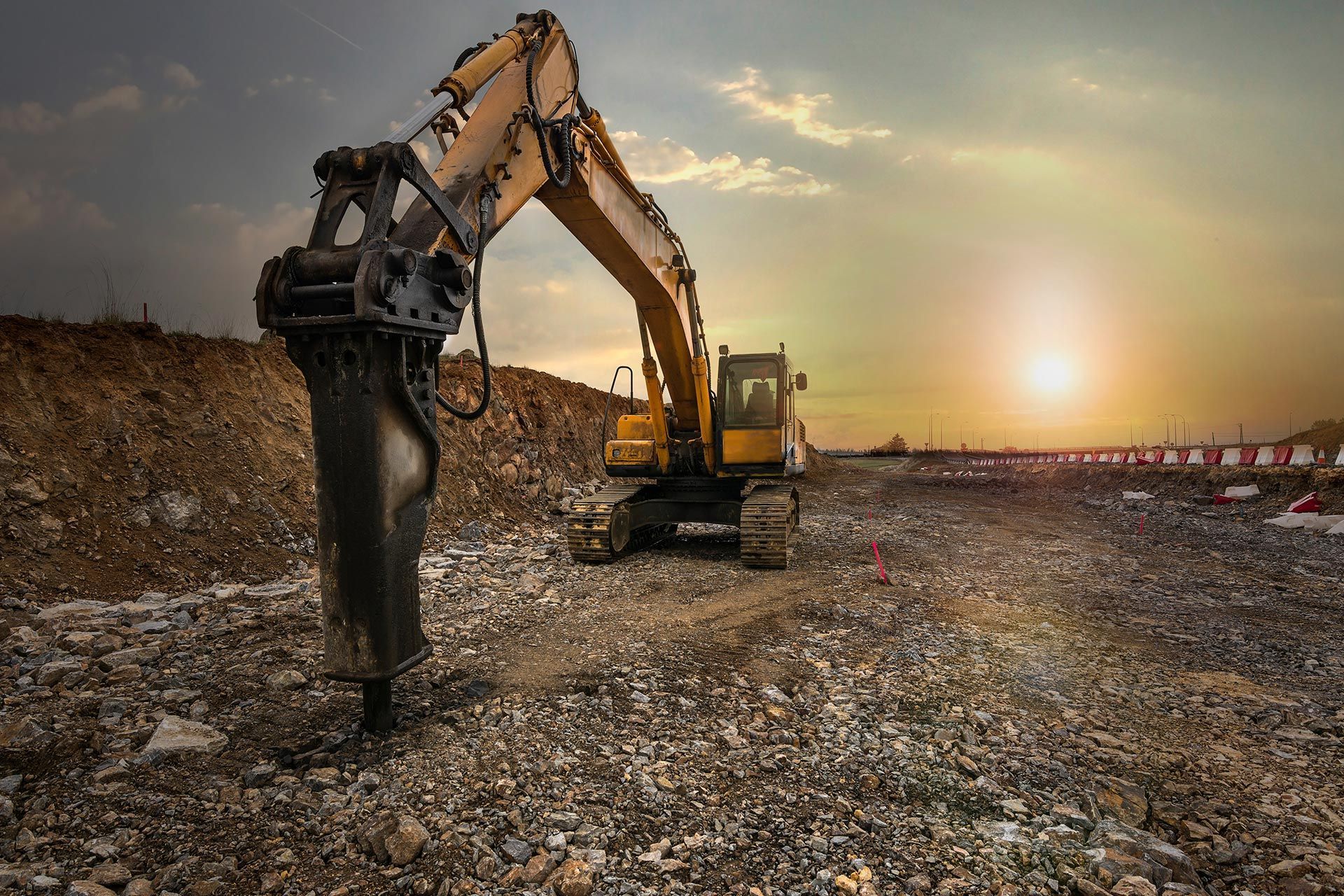 Excavator at a landfill at sunset, with a long arm lifting debris against a glowing sky Excavator at a landfill at sunset, with a long arm lifting debris against a glowing sky