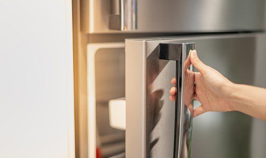 A person is pressing a button on a washing machine.