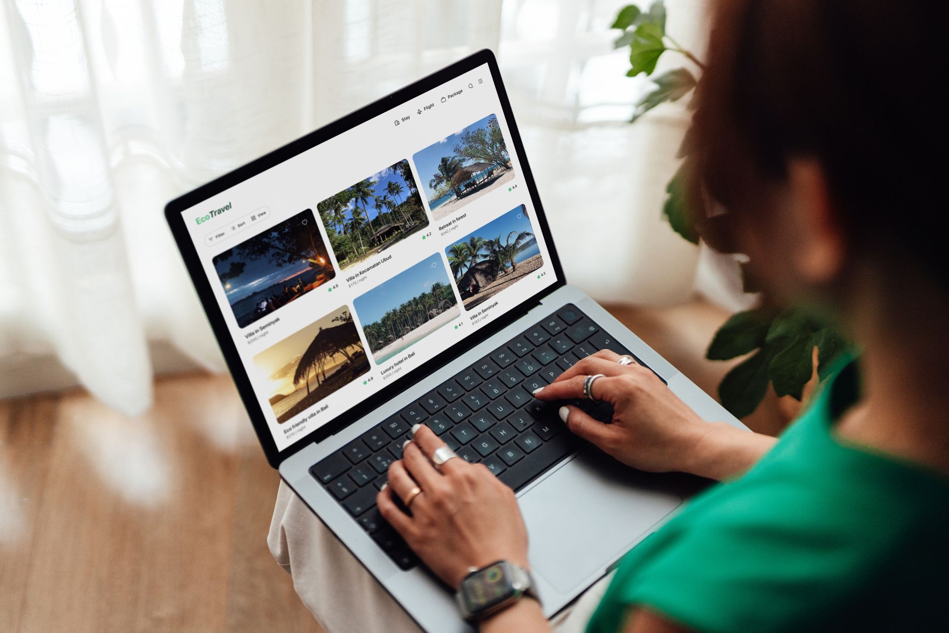 Person using laptop, browsing photos. Display shows a website with image previews.
