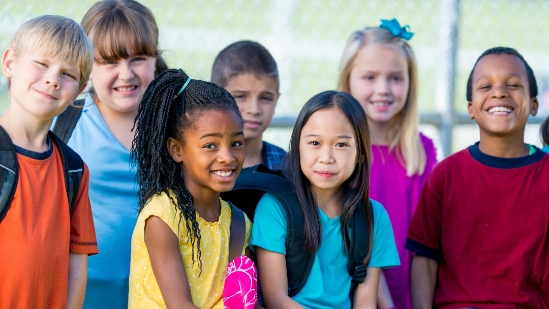 A group of children are posing for a picture together.