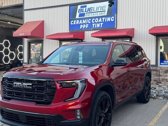 Red GMC SUV parked outside Blue Line Ceramic Coating and PPF Tint shop