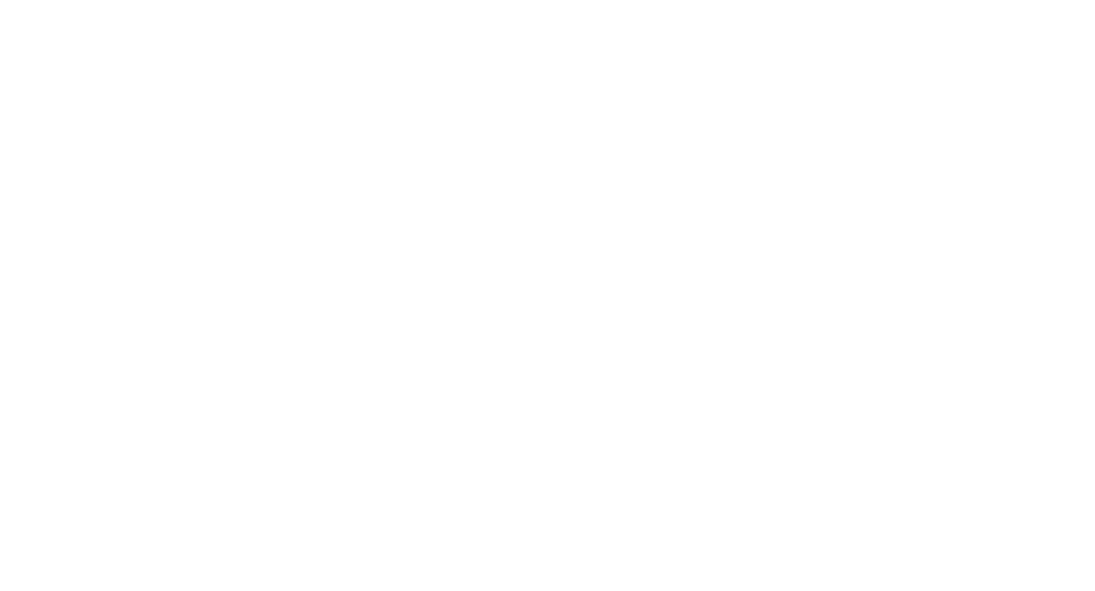 A blue sailboat is floating on top of a body of water.
