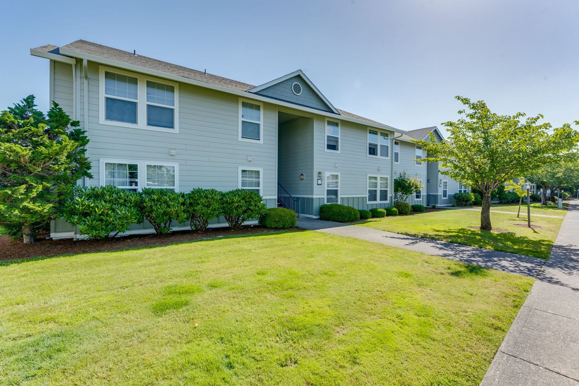 Building exteriors with manicured lawn.