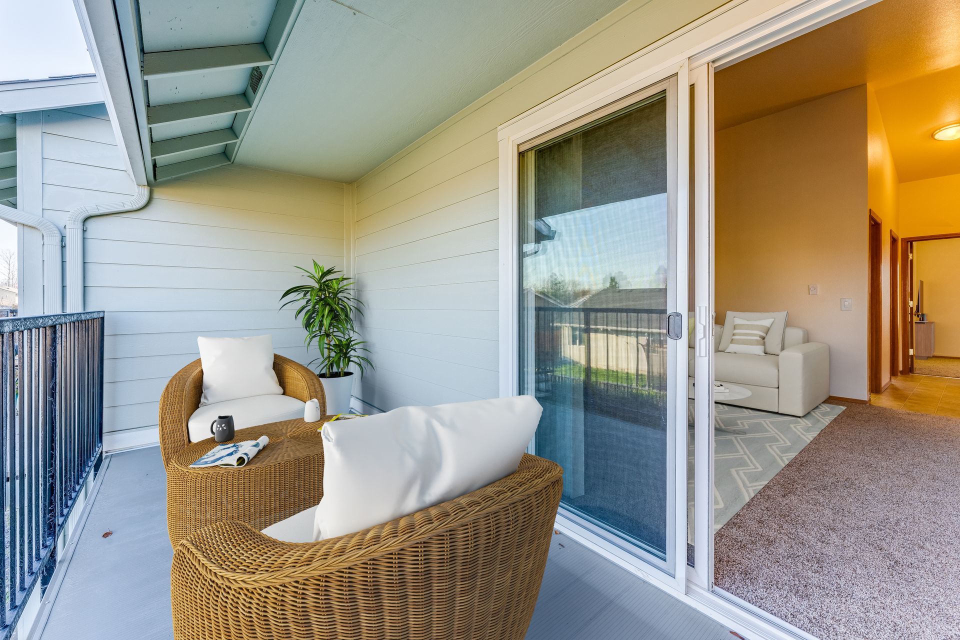 Back patio/deck off of living room through sliding glass doors.
