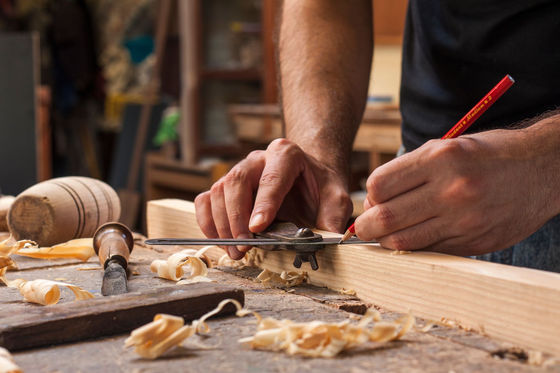 Two workers framing a wooden roof on a house under construction.