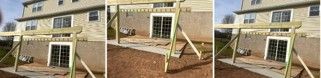 Damaged wooden porch swing hanging in front of a brick house with sliding glass doors and white railing.