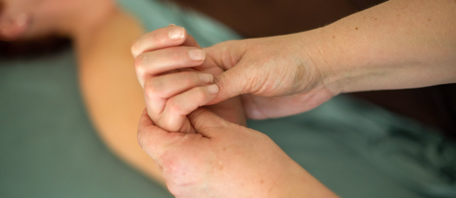A close up of a person getting a massage on their hand.