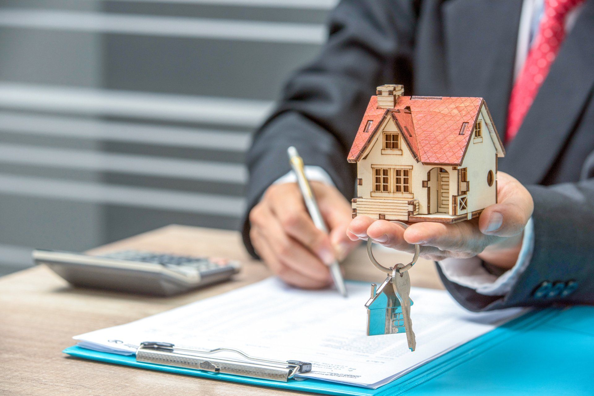 Lawyer Holding a House Model — High Point, NC – Truman Barker