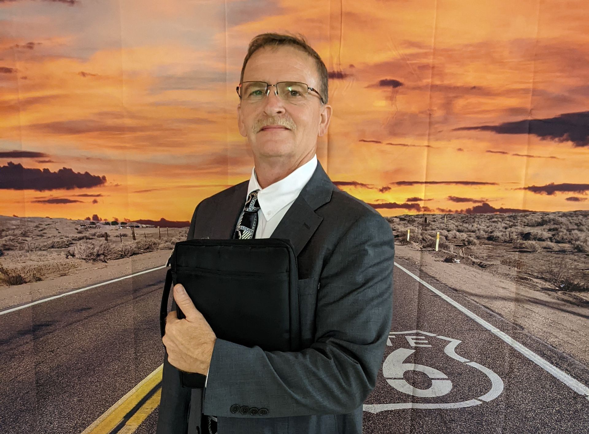 Pastor McMillian standing in front of a Route 66 sign.