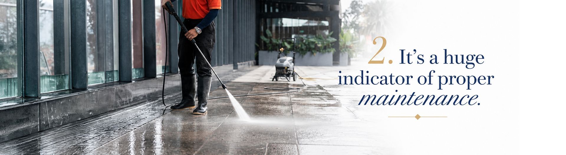 Worker pressure-washing a wet sidewalk beside glass windows, with text reading “It’s a huge indicator of proper maintenance.”