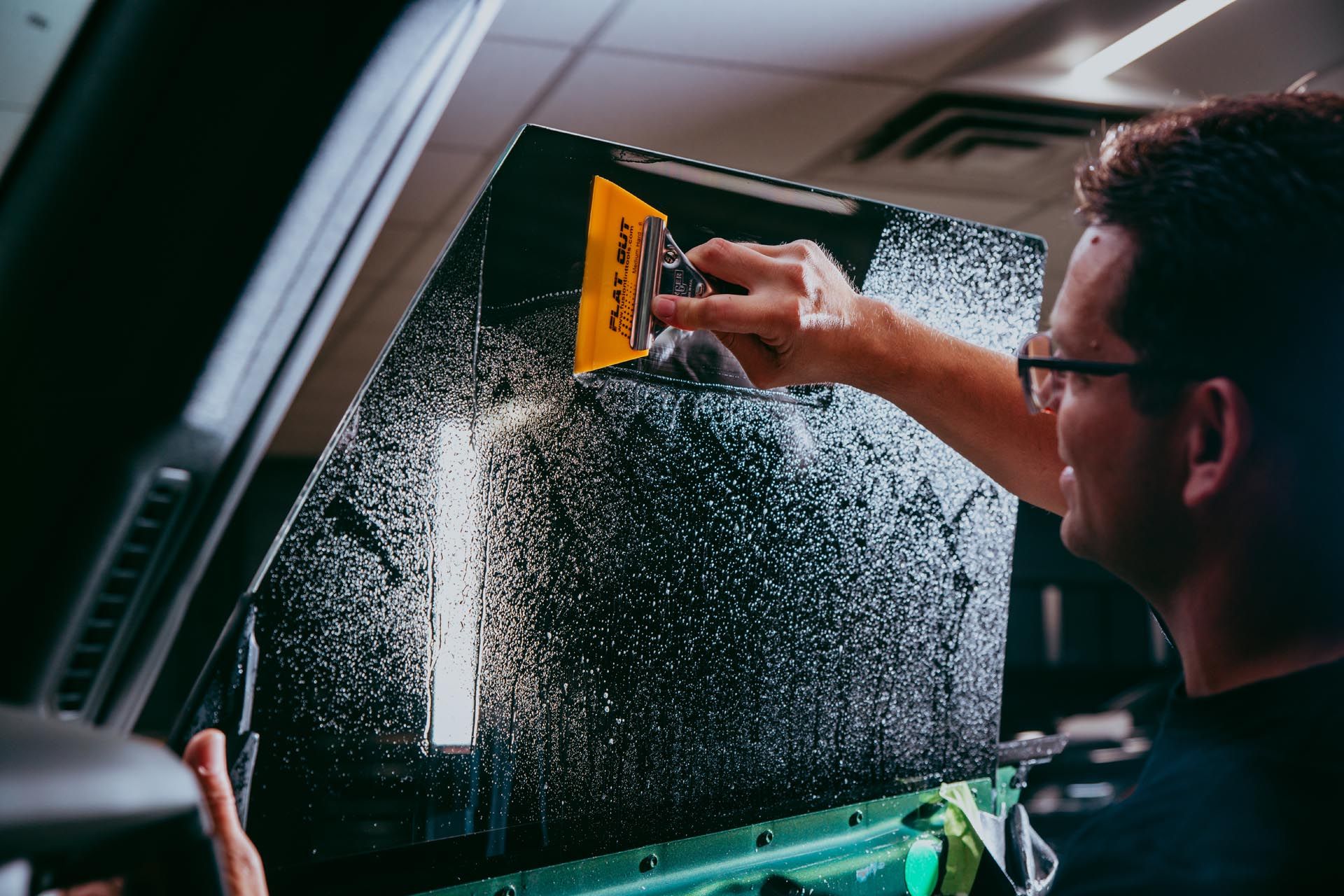 a man is using a tool that says flat out on it