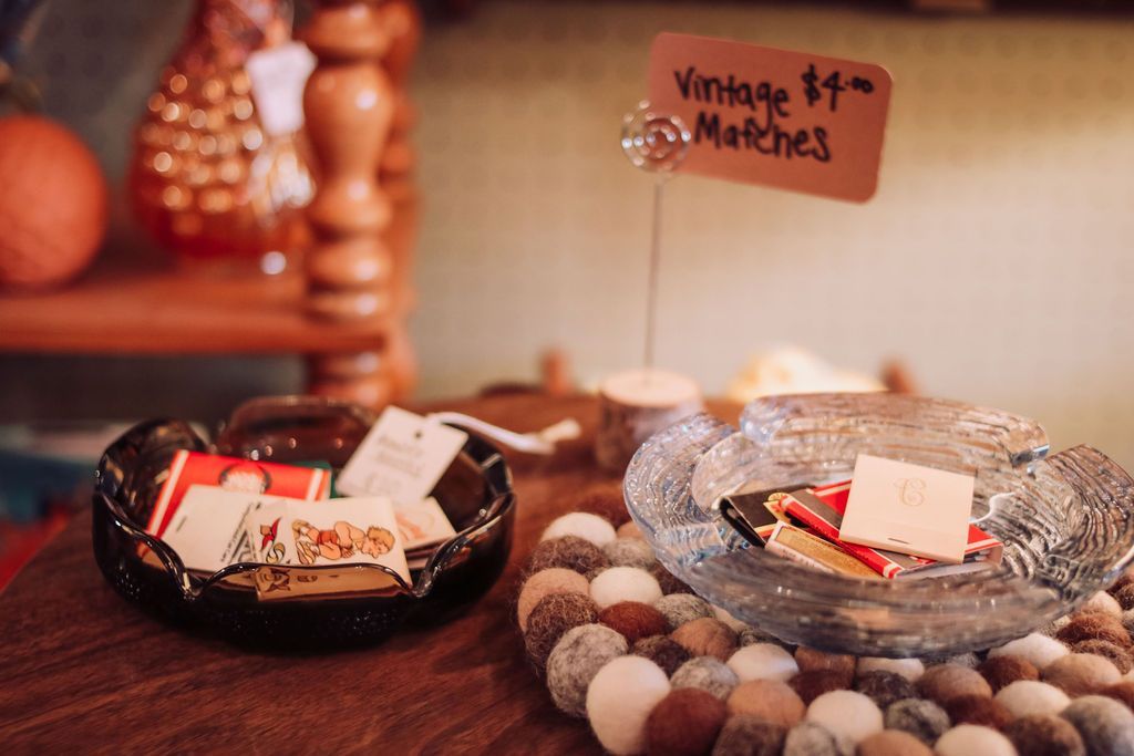 Vintage matches displayed in glass bowls, with a price tag.
