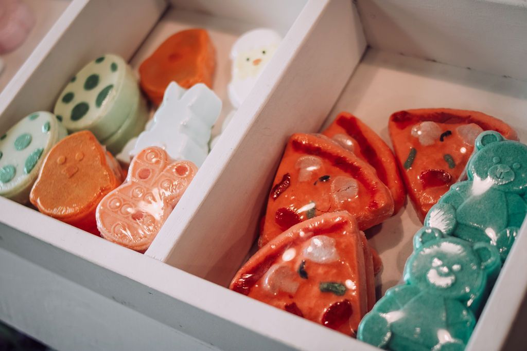 Box of colorful soaps shaped as food and animals.