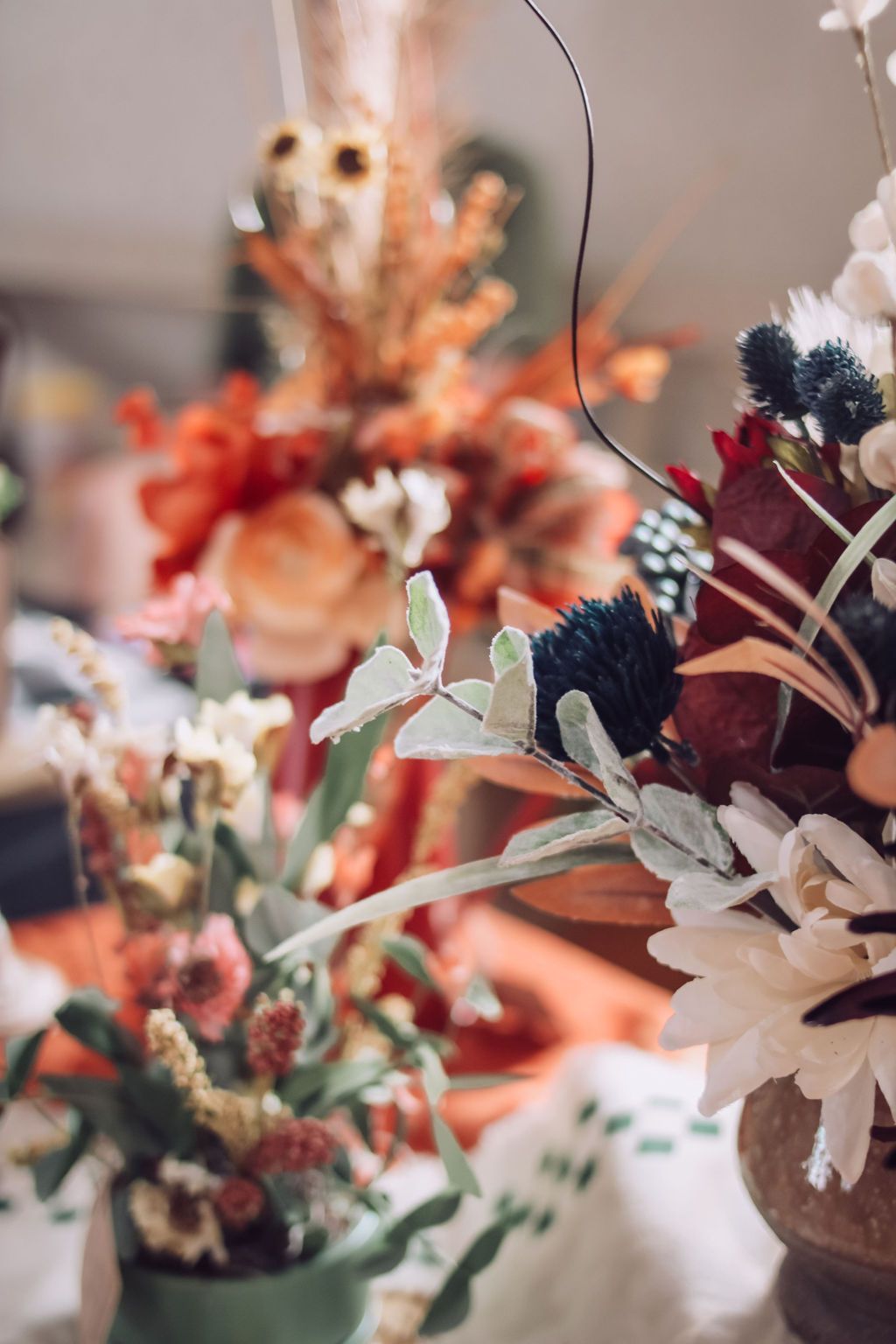 Close-up of colorful flower arrangements in vases, soft focus background.