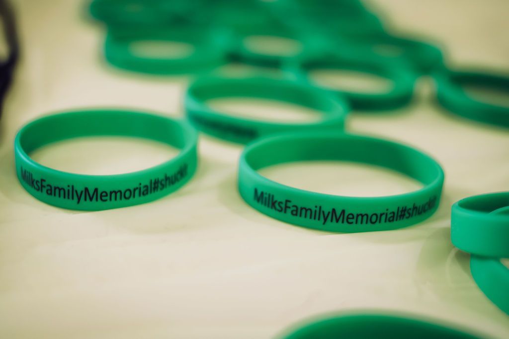 Green wristbands with the text 