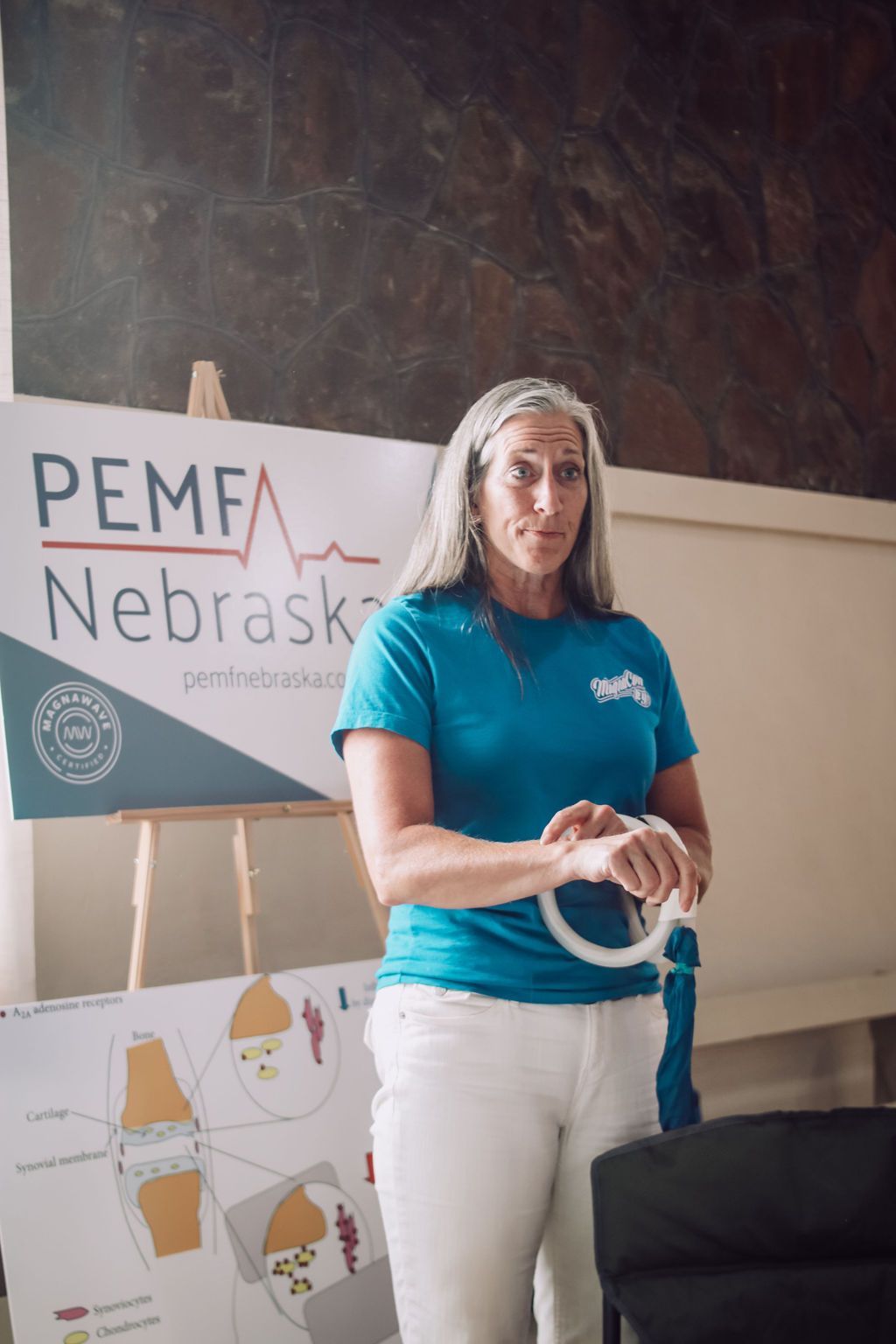 Woman presenting, holding white ring. 