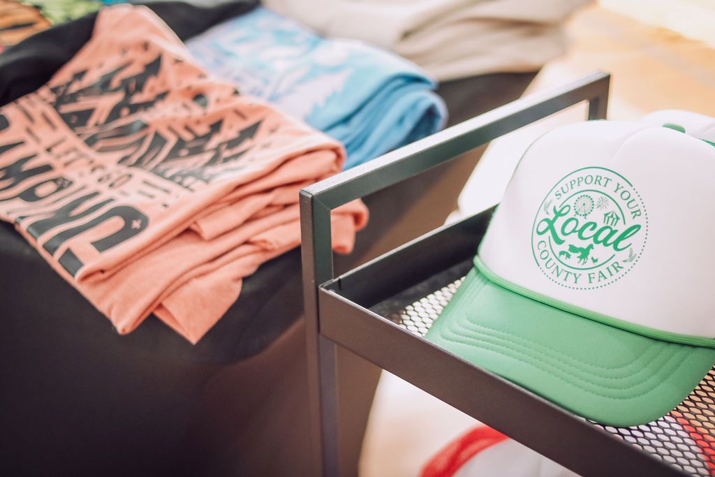 Shelving unit displays folded towels and a white and green 