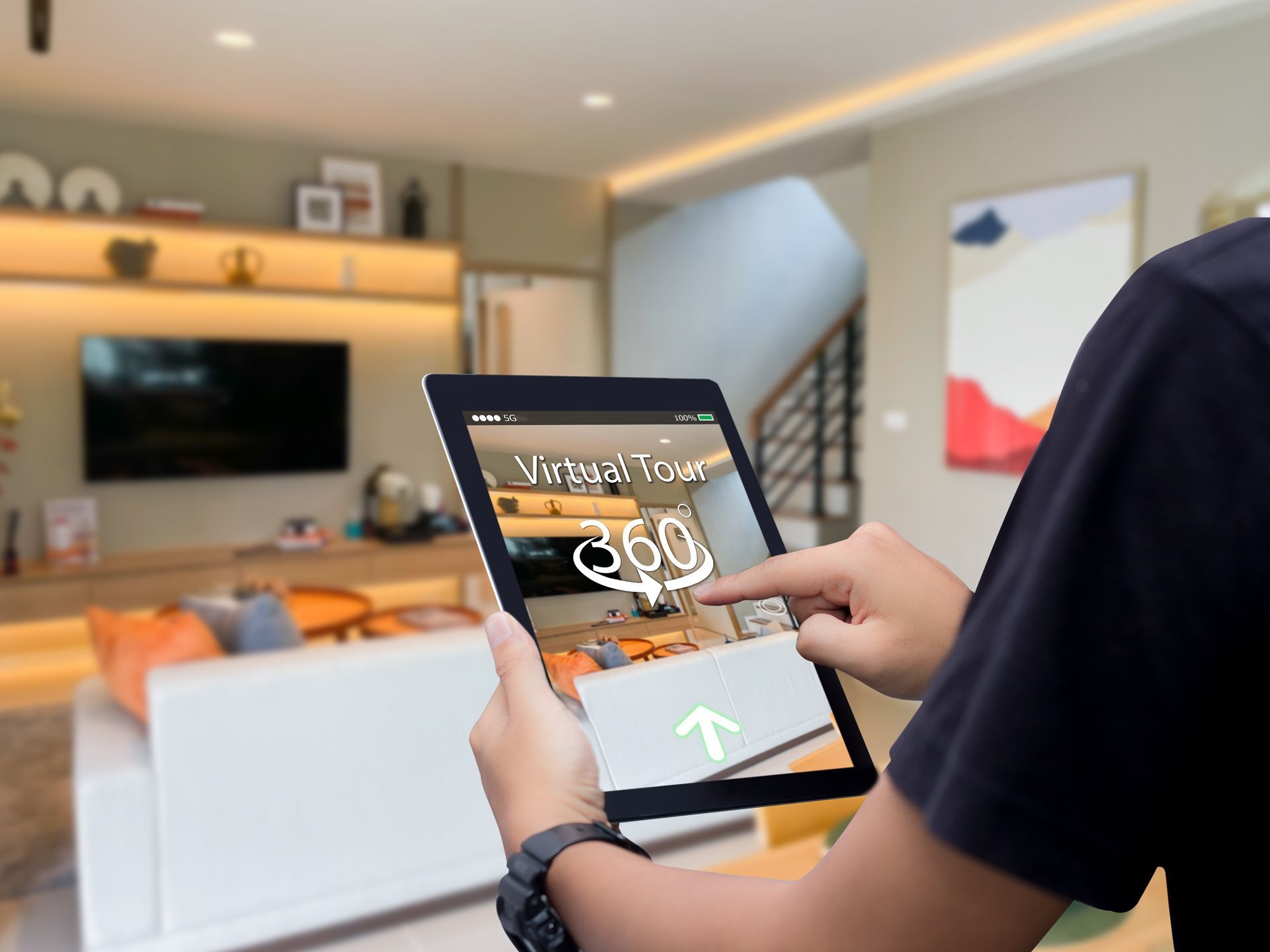 Person using a tablet in a modern living room, holding a digital payment or shopping app screen