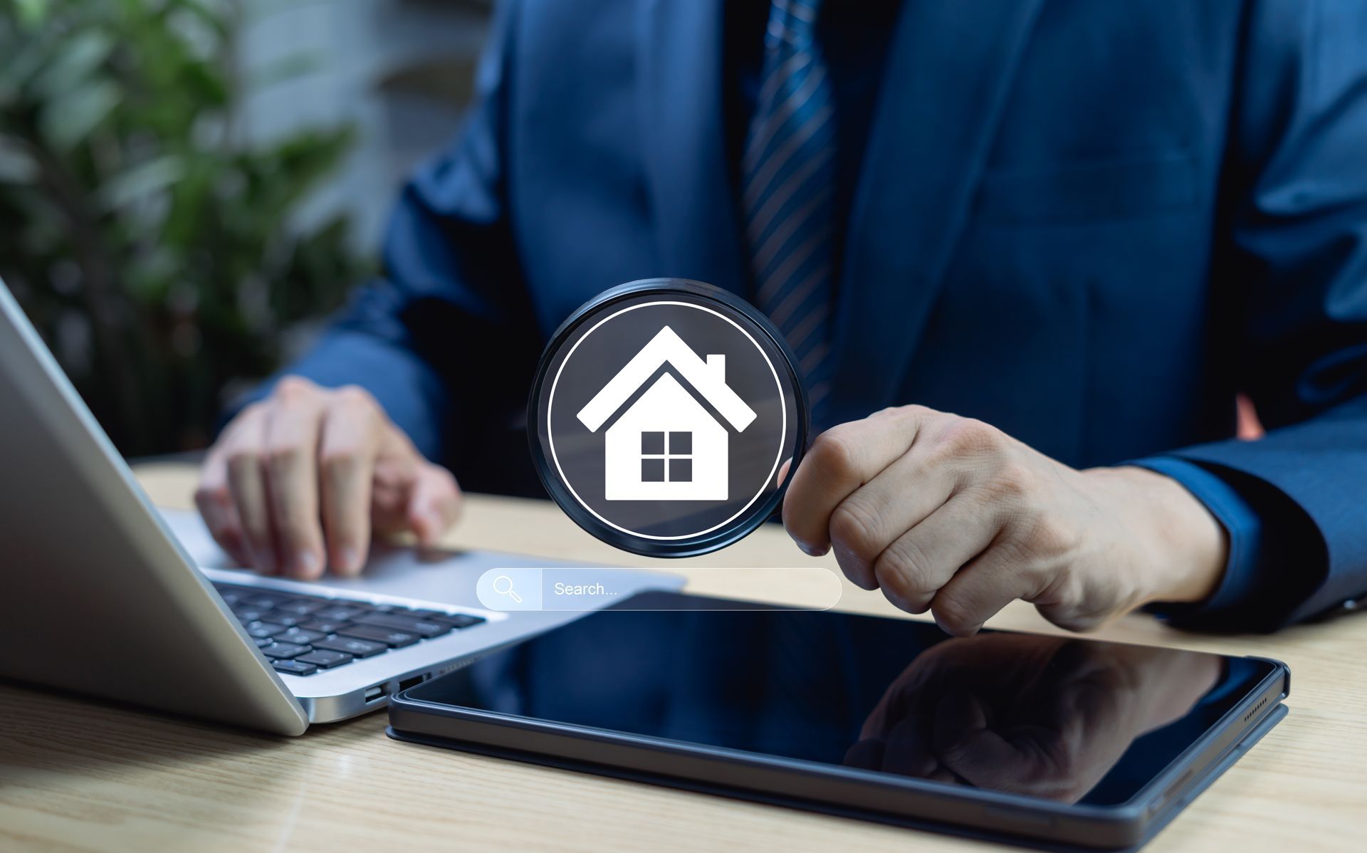 Businessperson signing home loan documents on laptop with house icon overlay