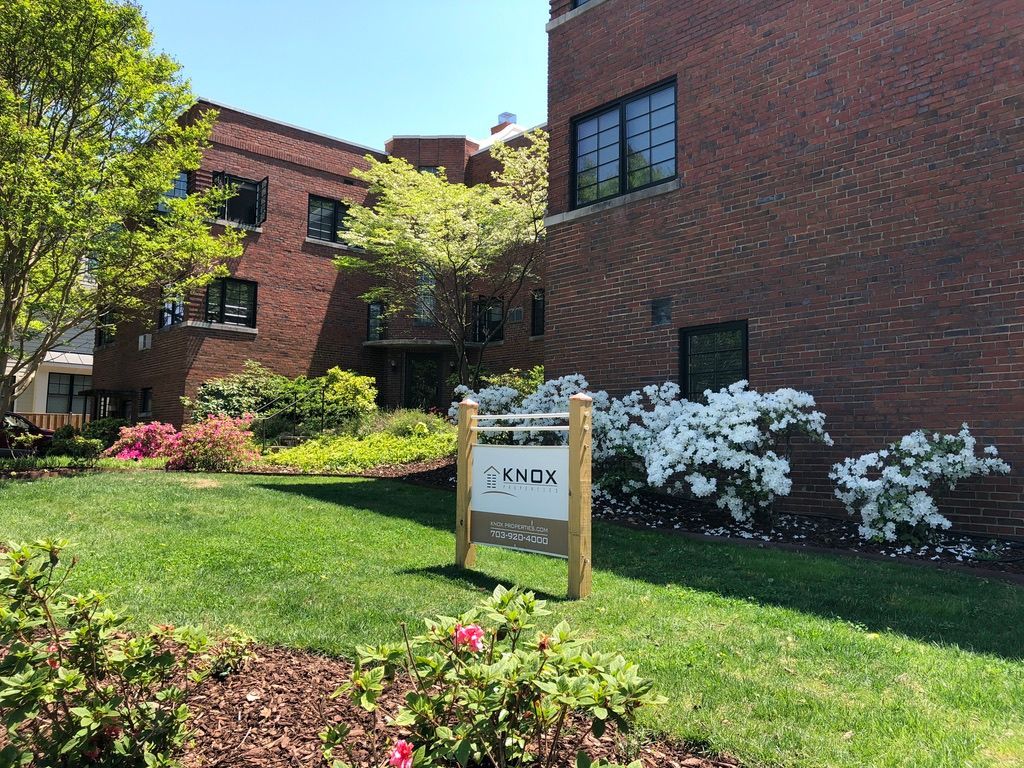 A brick building with a sign in front of it