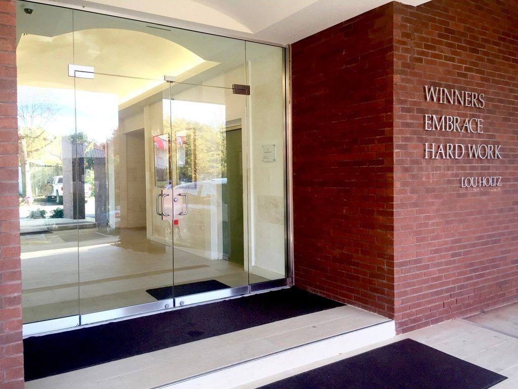 A brick building with a glass door and a sign that says winners