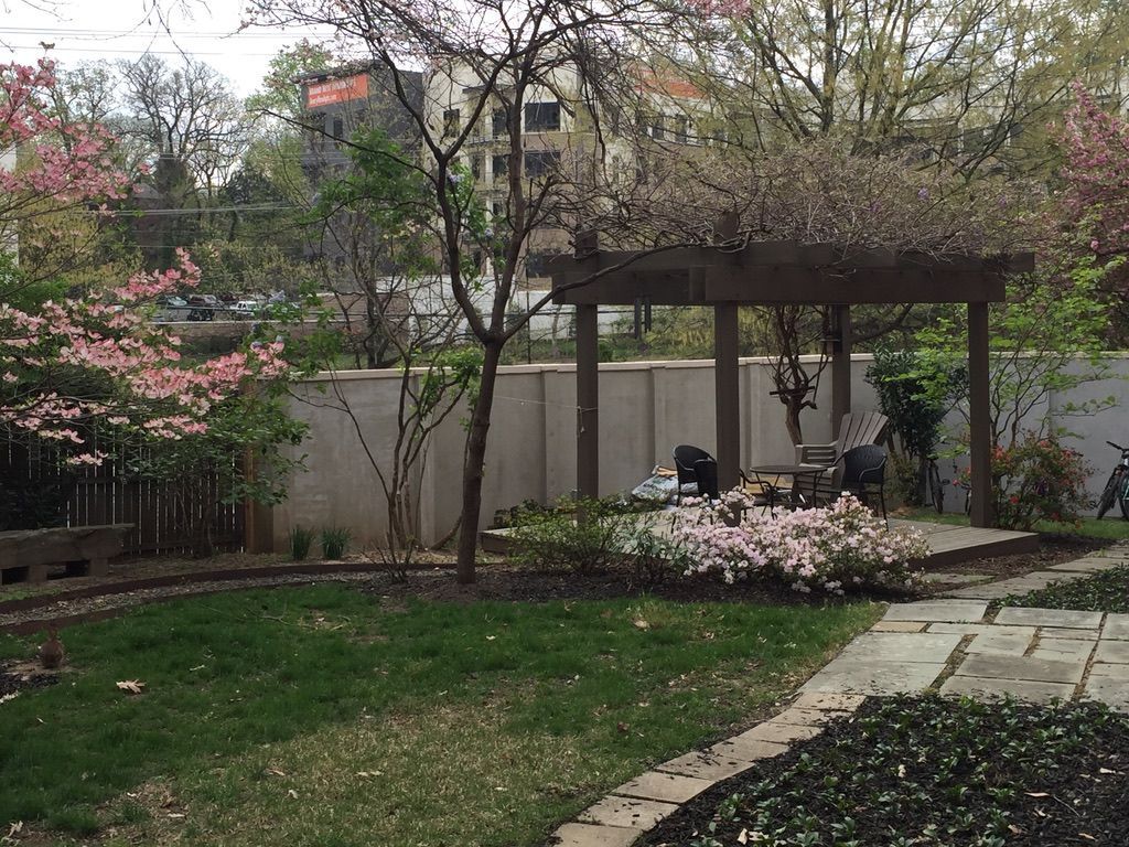 There is a pergola in the middle of the backyard.