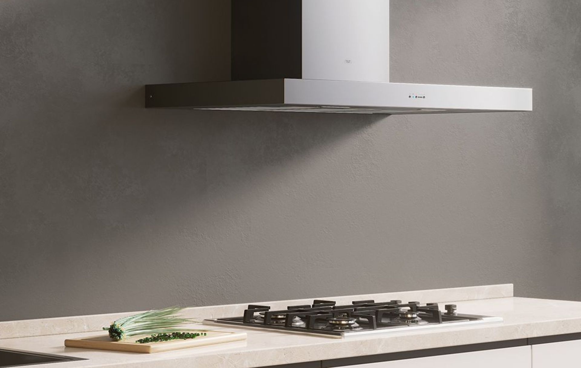 Encimera de cocina moderna con placa de gas, campana extractora y tabla de cortar con hierbas aromáticas.