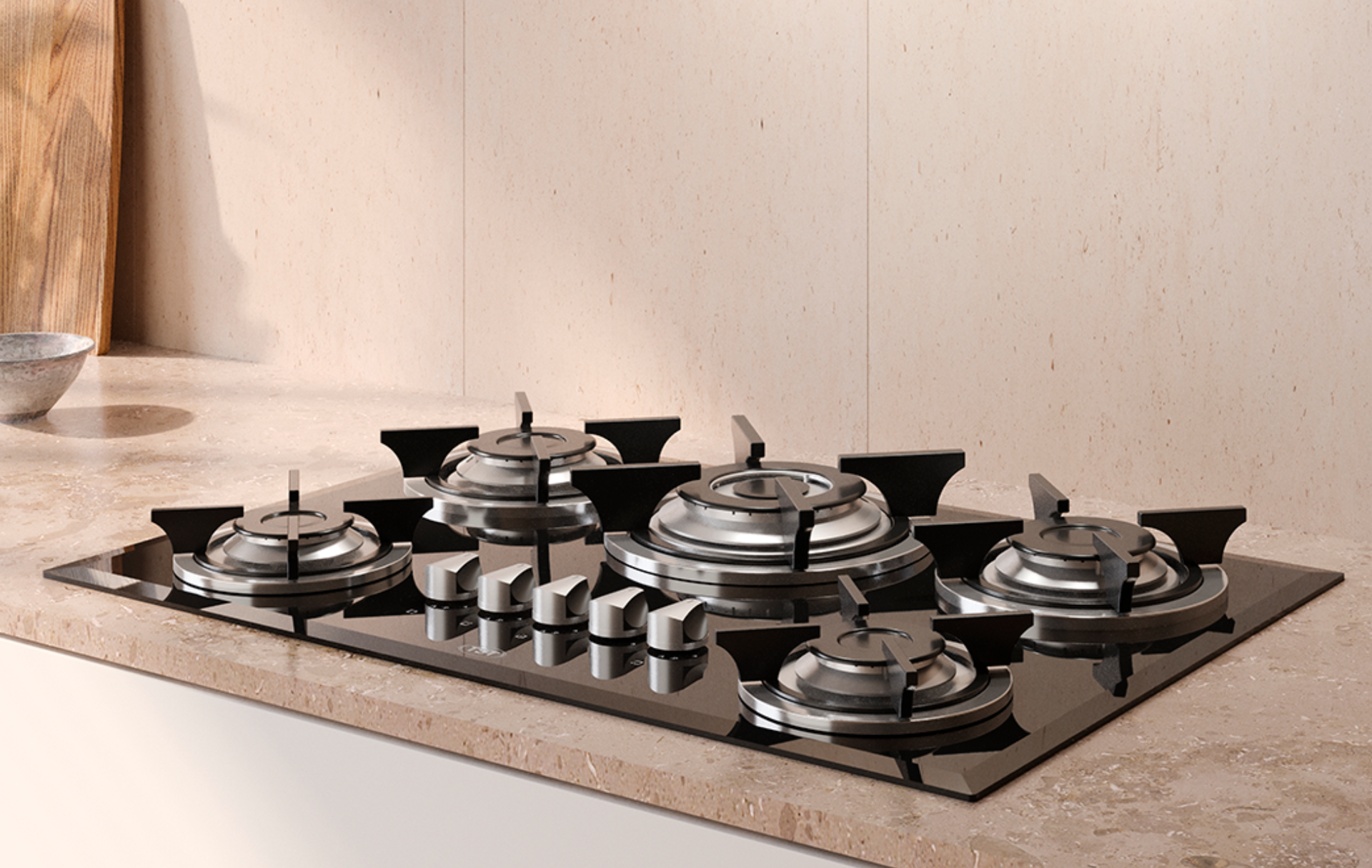 Placa de gas moderna de color negro con varios quemadores sobre una encimera beige en una cocina.