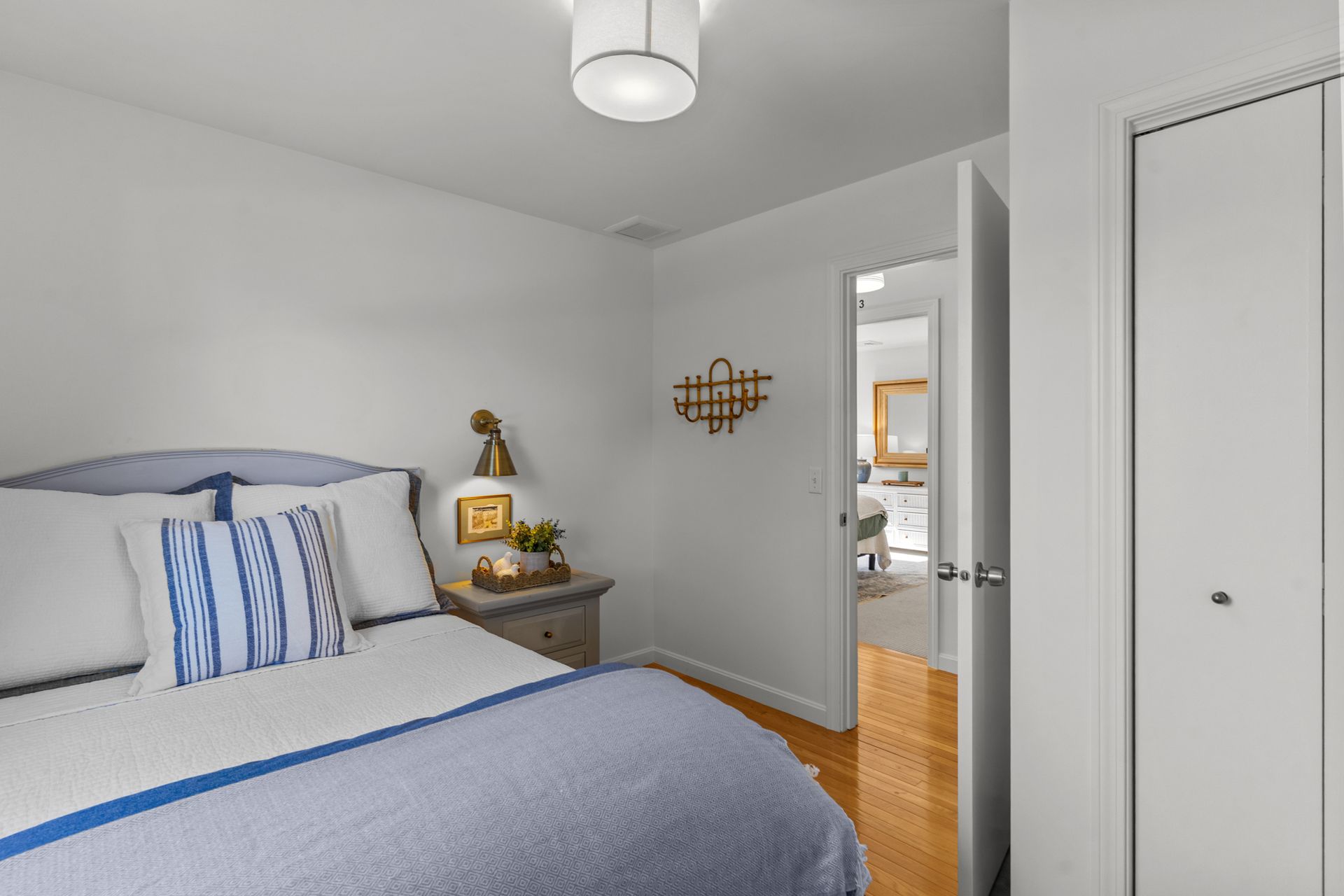 A bedroom with a bed , nightstand , and closet.