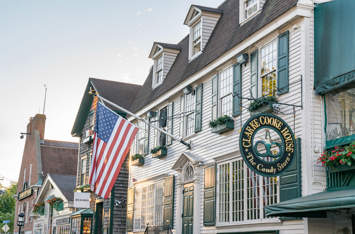 An american flag is hanging from the side of a building.