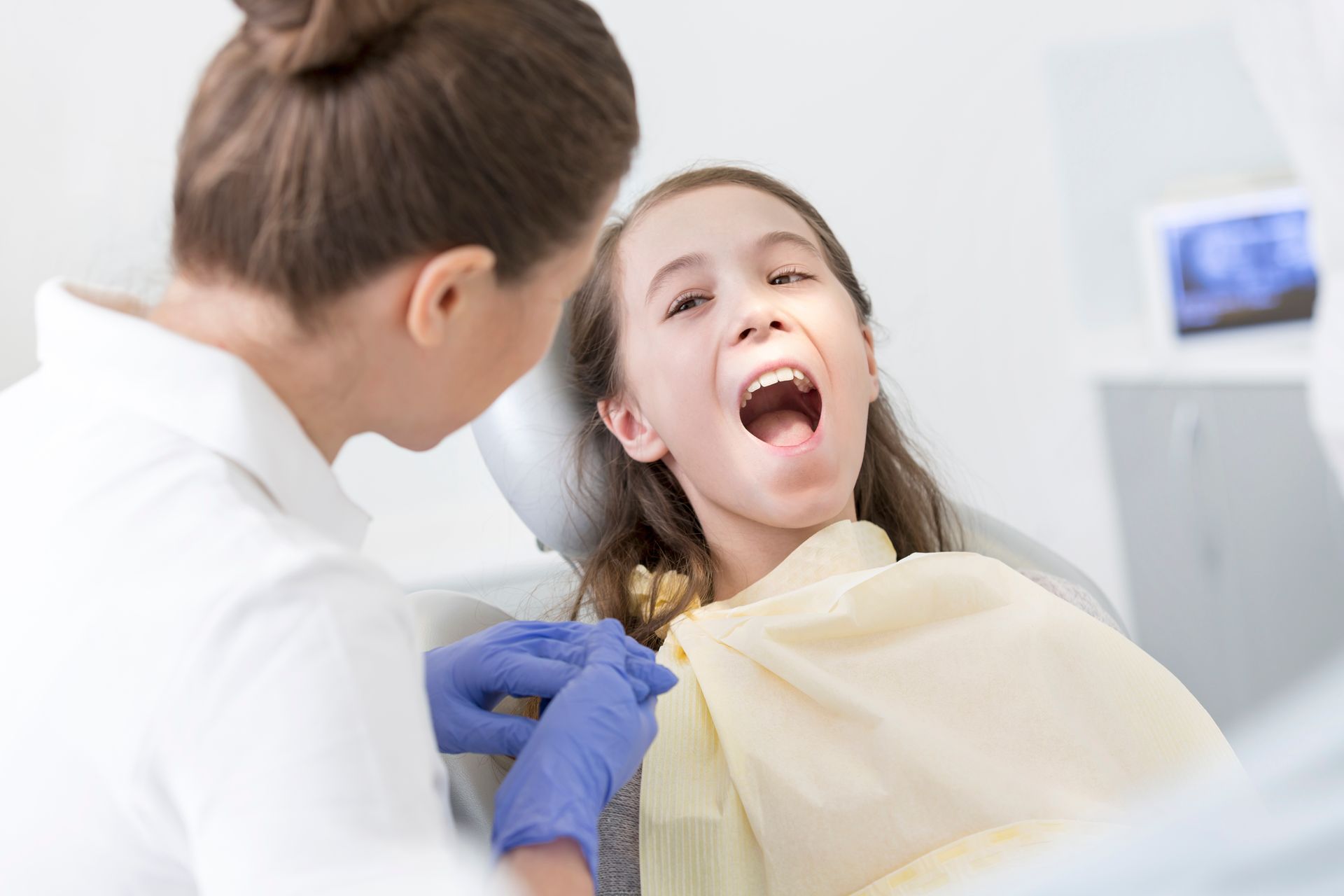 Doctor Checking the Girl's Teeth — Mermaid Waters, QLD — Gold Coast Dental & Denture Centre Doctor Checking the Girl's Teeth — Mermaid Waters, QLD — Gold Coast Dental & Denture Centre