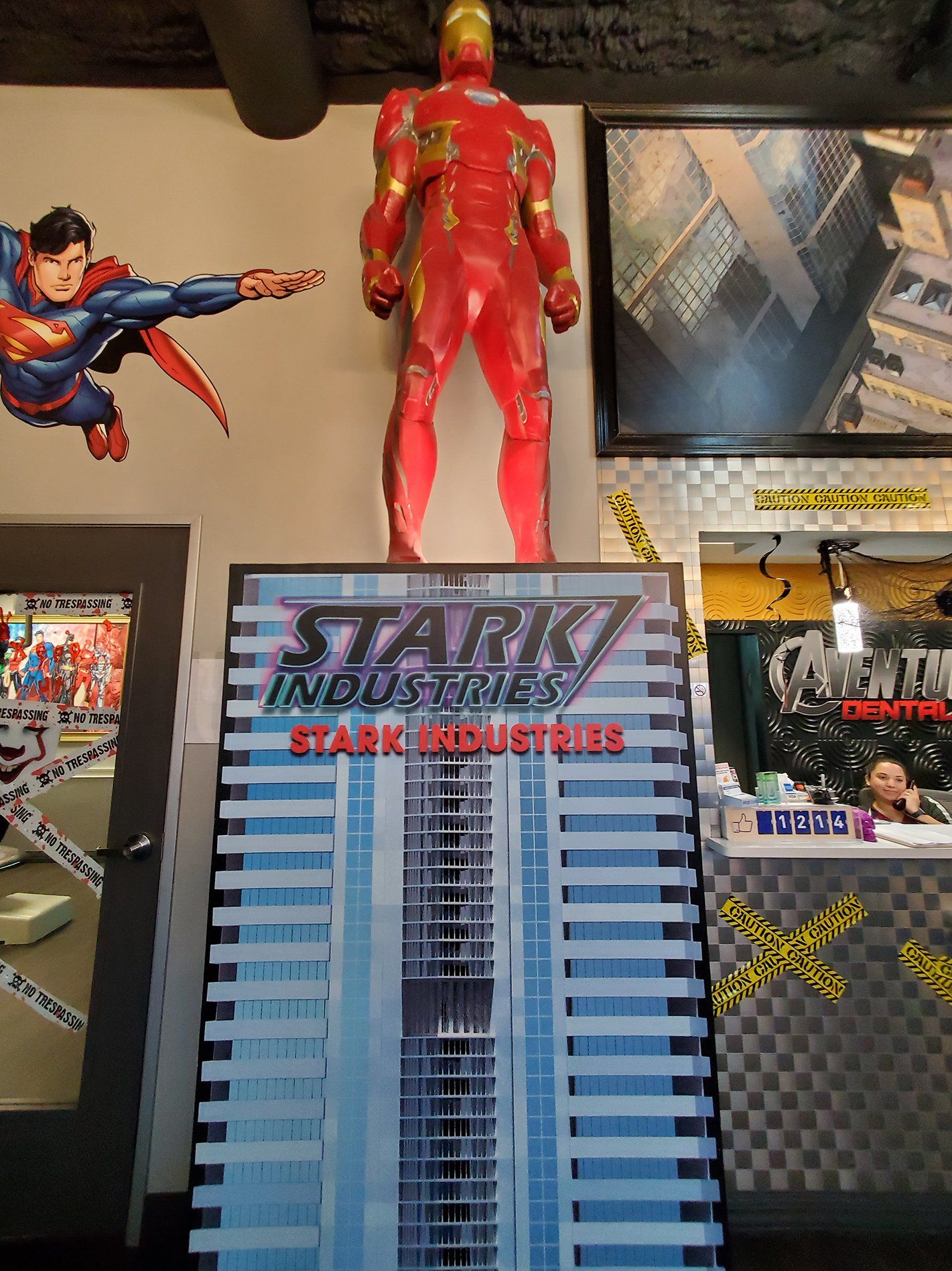 Superman and Iron Man figures above a Stark Industries model building display