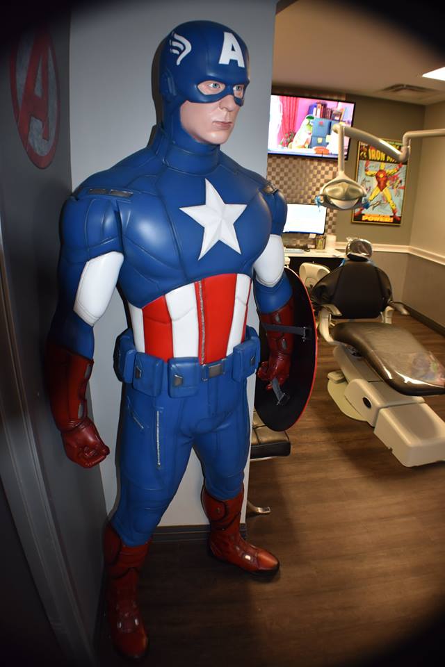 Captain America statue in a hallway, with blue suit, red gloves and boots, and white star emblem.