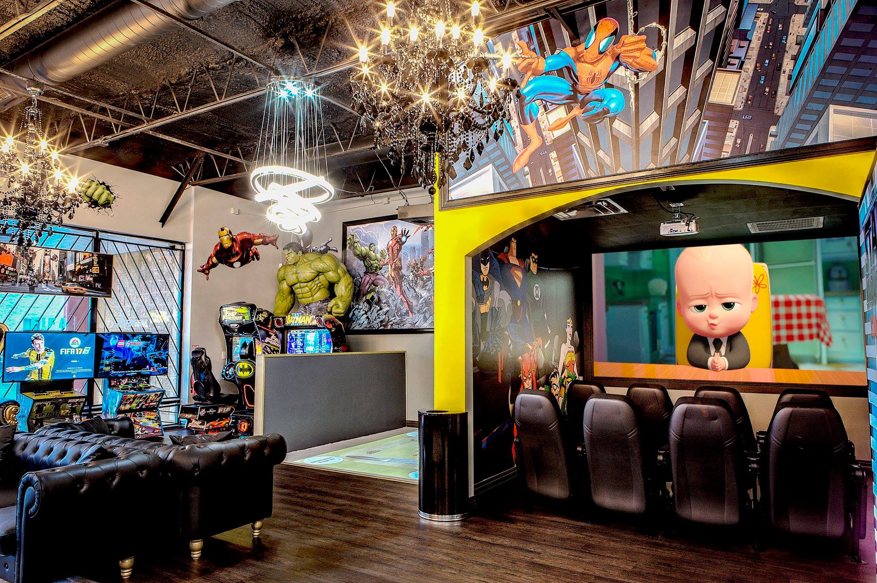 Colorful arcade room with neon lights, game cabinets, and a large cartoon baby display