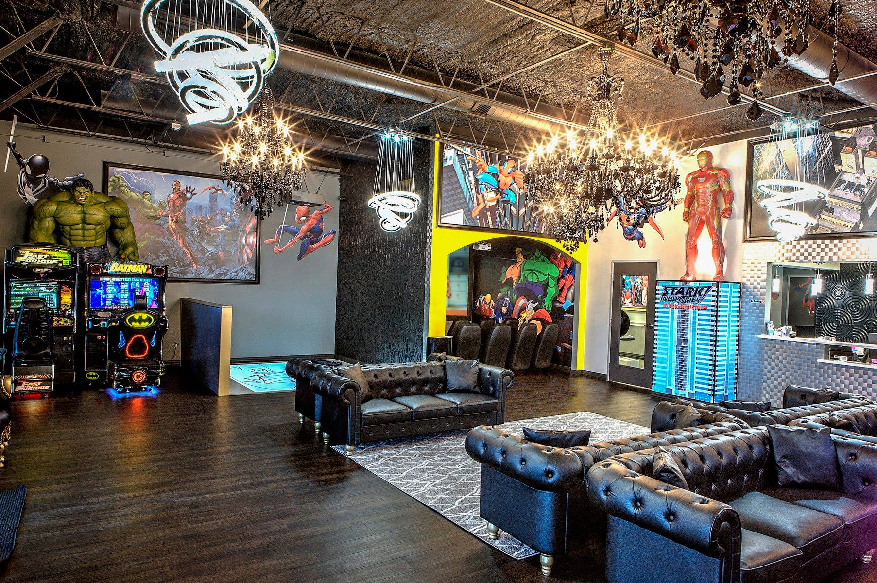 Neon-lit arcade lounge with black sofas, pool table, and arcade machines under a sparkling ceiling