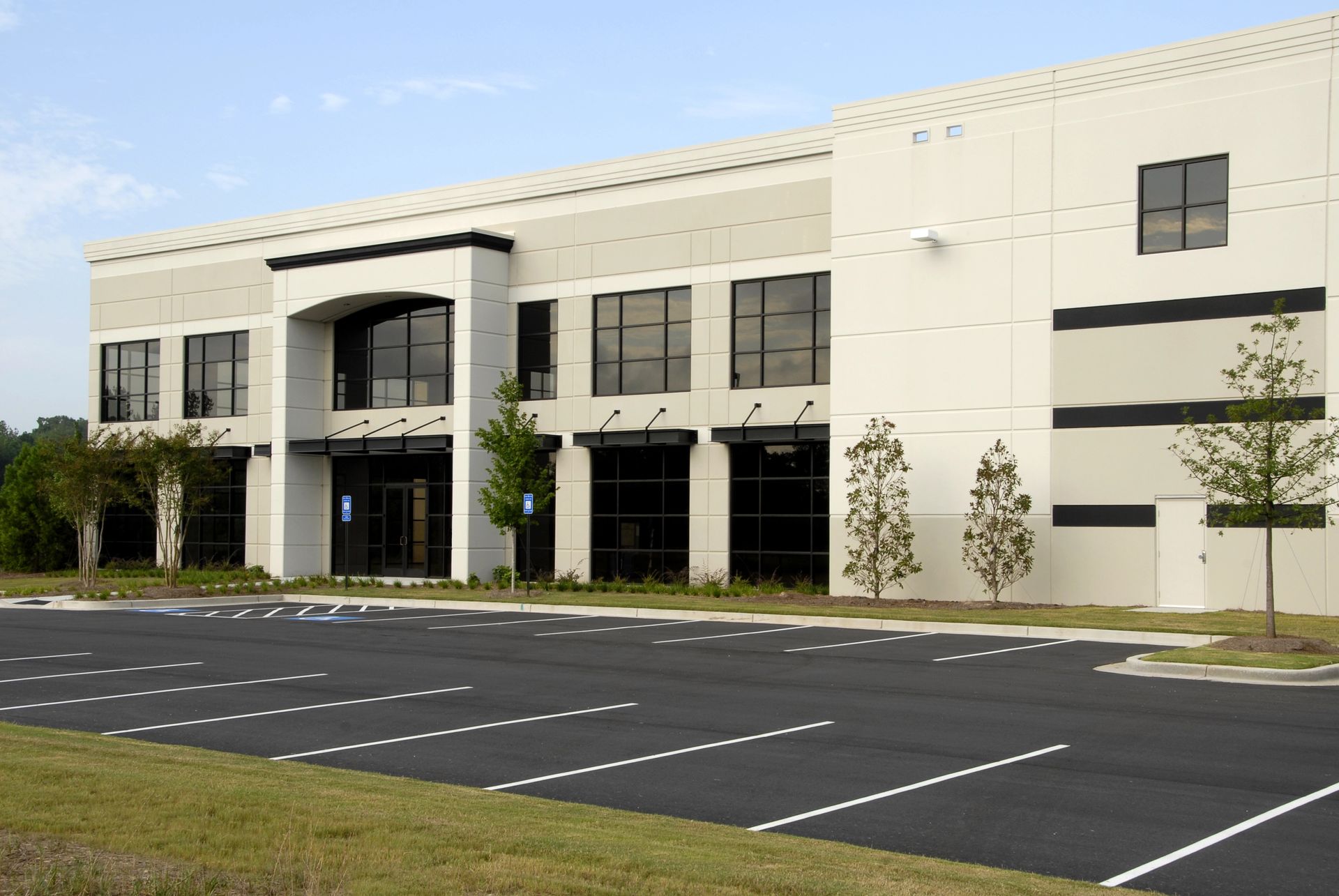 A large building with a parking lot in front of it