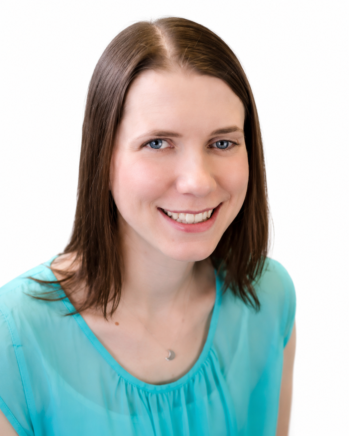 A woman in a blue shirt is smiling for the camera.